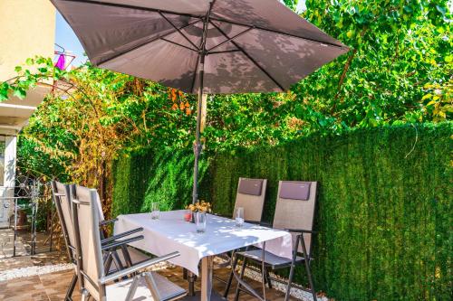 a table and chairs with an umbrella on a patio at Sweet Home 1 in Sandanski