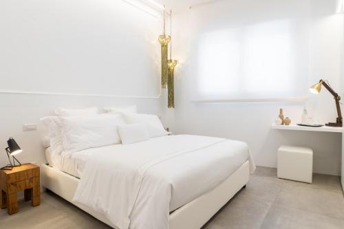a white bedroom with a white bed and a window at Nest House & Relax in Civitanova Marche