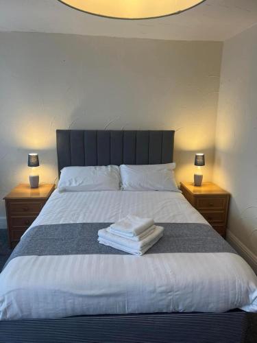 a bedroom with a large bed with two night stands at The Ship and Pilot Inn in Ilfracombe