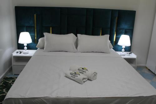 a large white bed with two towels on it at Yassers Residence in Er Rachidia