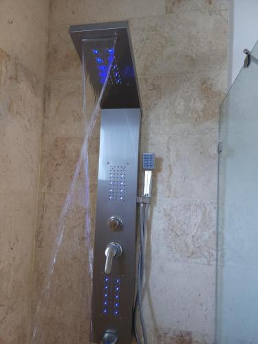 a shower in a bathroom with a glass door at Bella Villa Roomy apartment at 5 min walk to the beach in Las Galeras