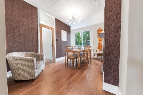 a kitchen and dining room with a table and chairs at Sunny Brae, dog friendly Windermere Cottage in Windermere