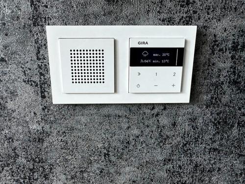 a clock on top of a concrete wall at Apartment Düsseldorf-Lohausen in Düsseldorf