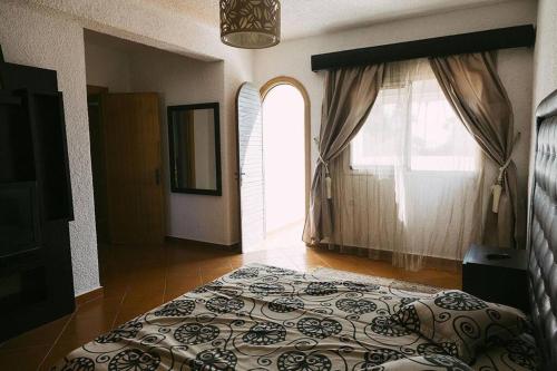 a bedroom with a bed and a window at Villa Vue sur la Méditerranée in Cabo Negro