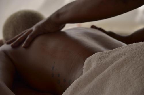 a close up of a persons stomach with a hand on it at Mem Luxury Apartments and Hotel in Paje