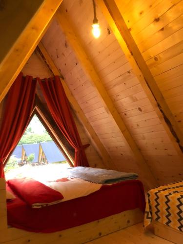 a bed in the attic of a tree house at Etno apartmani Komarnica in Šavnik