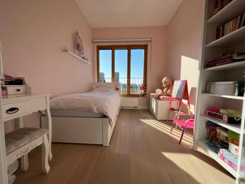 a bedroom with a bed and a desk and a window at Luxury apartment, private terrace & FREE PARKING in Antwerp