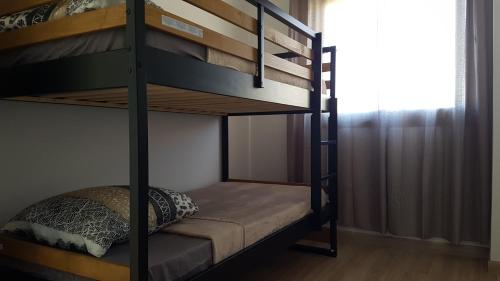 a bedroom with bunk beds in a room with a window at Le P'tit Rubis in Le Tampon