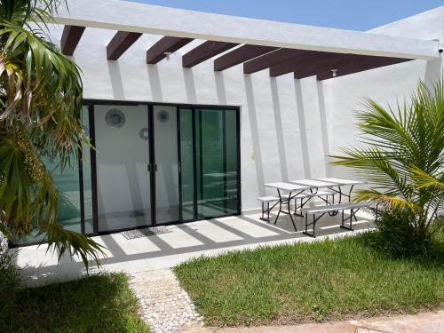 a patio with tables and chairs on a building at Villas Miland - San Benito Beach in San Benito