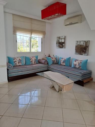 a living room with two couches and a table at Villa de rêves in Casablanca