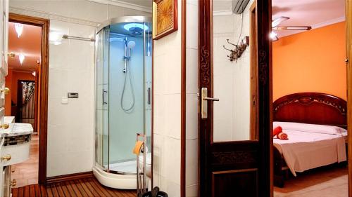a bathroom with a shower and a bedroom with a bed at La Bohemia Casco Antiguo in Calpe