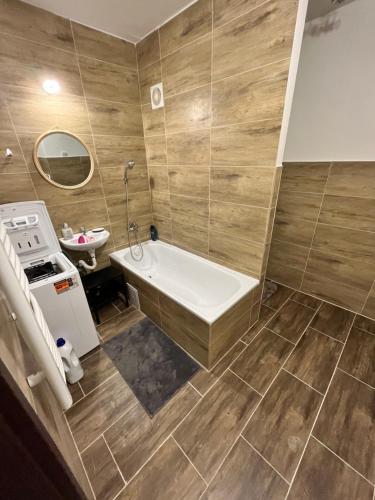 a bathroom with a bath tub and a sink at Free Wifi - Urban Oasis Rentals in Bratislava