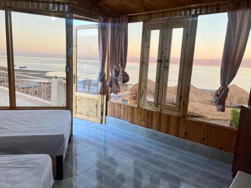 NuweibaにあるPanorama Lodge Nuweibaのベッドルーム1室(ベッド2台付)が備わり、海の景色を望めます。
