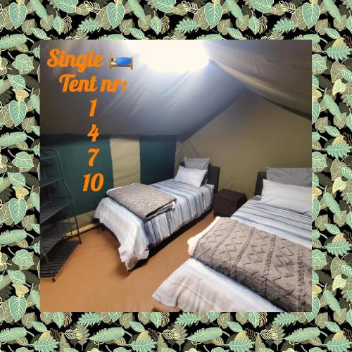 a room with two beds in a tent at Peace Haven @ Windfarm Accommodation in Yzerfontein