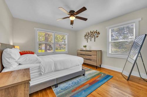 a bedroom with a bed and a ceiling fan at NEW! Modern Luxury w/ Pool Table 3BR/5BD Sleeps 10 in Decatur