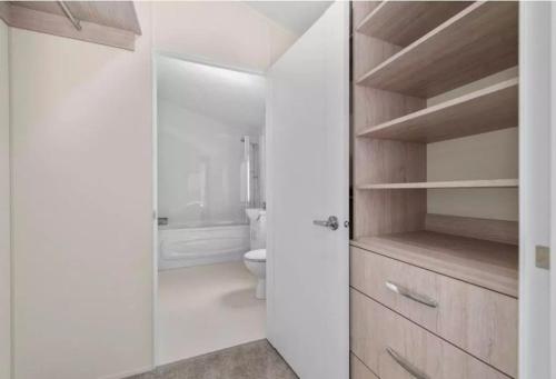 a white bathroom with a toilet and a shower at Rivers Edge in Dollar