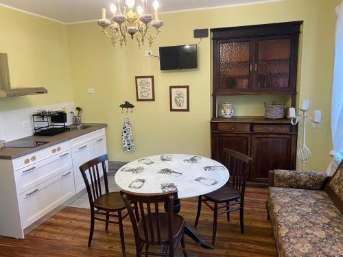 a kitchen and dining room with a table and chairs at Cascina Vica Biella in Andorno Micca