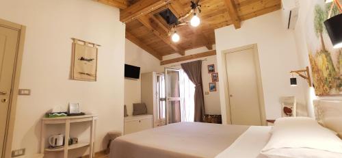 a bedroom with white walls and wooden ceilings at B&B Mastro Francesco in Scilla