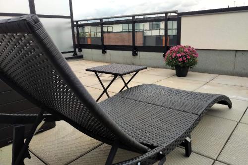 a black chair and a table on a balcony at GGP Boutique Townhome in Vaughan