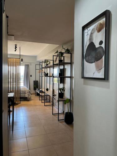 a living room with a bunch of shelves with plants at Bernabe Boulevard in San Miguel de Tucumán
