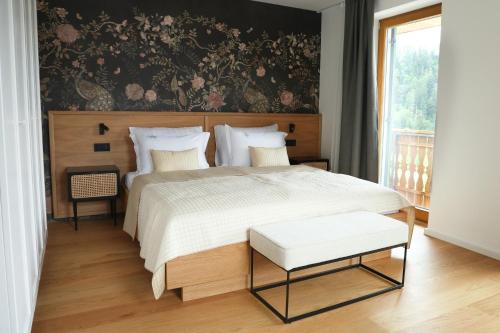 a bedroom with a large bed with a floral wallpaper at Villa Rodica, Bled in Bled