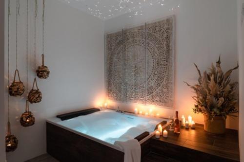 a bath tub in a room with candles and lights at Nest House & Relax in Civitanova Marche