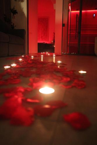 a group of red flowers on the floor with lights at Nest House & Relax in Civitanova Marche