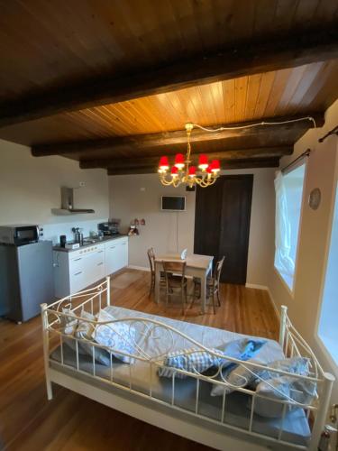 a bedroom with a bed and a dining room at Cascina Vica Biella in Andorno Micca