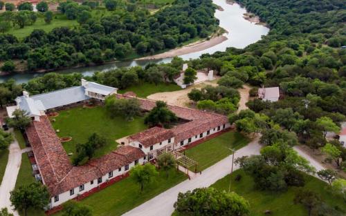 an aerial view of a building with a river in the background at Rest Yourself River Ranch in Mineral Wells