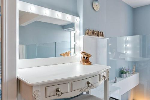 a bathroom with a sink and a mirror at Let's go sea in Swansea