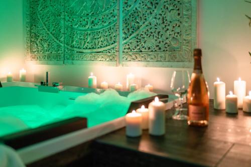 a bottle of champagne and candles on a table at Nest House & Relax in Civitanova Marche