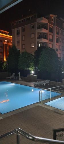 a large swimming pool at night with a building at Apartment in Antalya Konyaaltı in Antalya