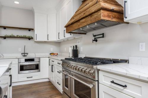 a kitchen with white cabinets and a stove top oven at Sunset Stay at 608 in Wormleysburg