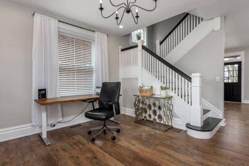 a home office with a desk and a staircase at Sunset Stay at 608 in Wormleysburg