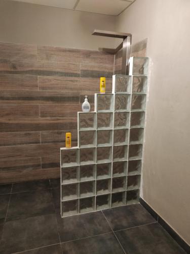 a metal shelving unit in a room with a wall at Apart Trelew in Trelew