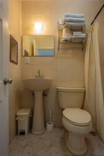 a bathroom with a toilet and a sink at Marysol private beach D12 next to nomads in Isla Mujeres
