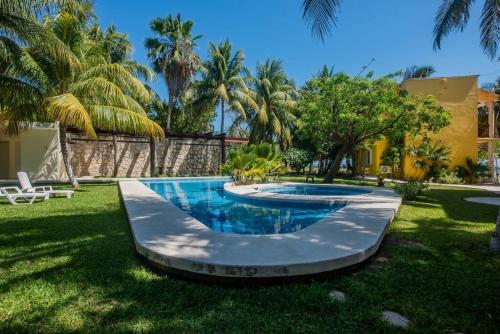 a swimming pool in the yard of a house at Marysol private beach D12 next to nomads in Isla Mujeres