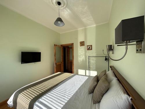 a bedroom with a bed and a flat screen tv at Waterfront Terrace House Bosphorus Istanbul in Istanbul