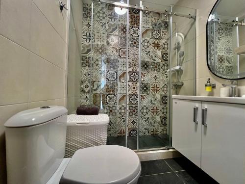 a bathroom with a toilet and a shower at Acacia Hills B1 in Đenovići