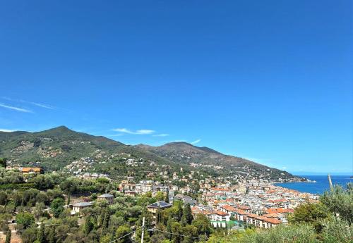 a view of a town on a hill next to the ocean at Dolce Far Niente in Alassio