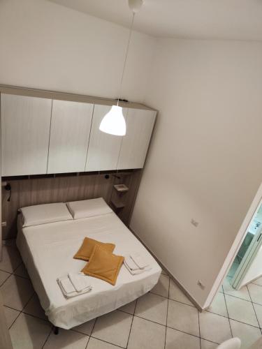 a small room with a bed and a light at Domenico 's in Ruvo di Puglia