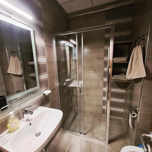 a bathroom with a shower and a sink at Lena_Lux in Jagodina