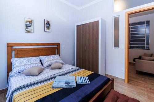 a bedroom with a bed with towels on it at Studio 112 Campinas SP in Campinas