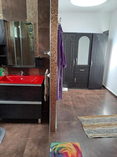 a bathroom with a red sink and a mirror at Villa de rêves in Casablanca