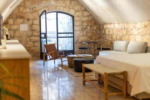 a room with two beds and a window at Hagafen Boutique Suites in Zikhron Ya‘aqov