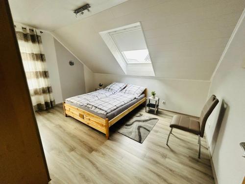 a bedroom with a bed and a skylight at Ferienwohnung auf dem Fels in Kall