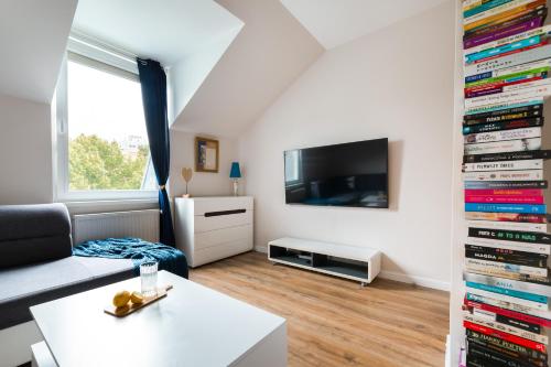 a living room with a large wall of dvds at Family Apartment - Centrum in Kudowa-Zdrój