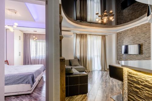 a hotel room with a bed and a living room at Cozy Apartment in Tbilisi City