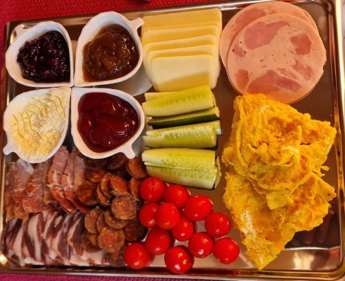 a tray of food with different types of foods at Lavanda Carasova in Caraşova