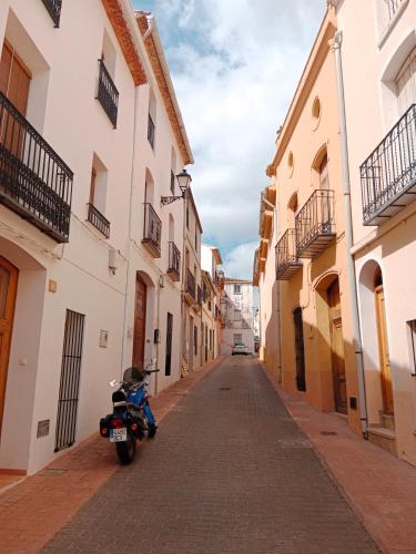 a motorcycle parked on a street between two buildings at La Milotxa in Adsubia